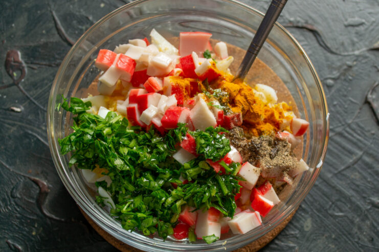 Tip: Use fresh herbs like parsley, dill, or basil to enhance the flavor. Adding freshly chopped parsley to the salad ingredients in the bowl.
