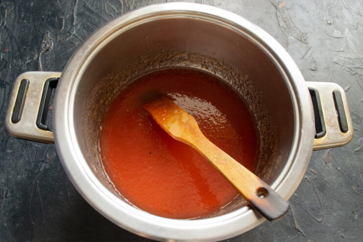 Getting the Fruit Puree Ready for Whipping Cooled apple-plum puree in a large metal mixing bowl.