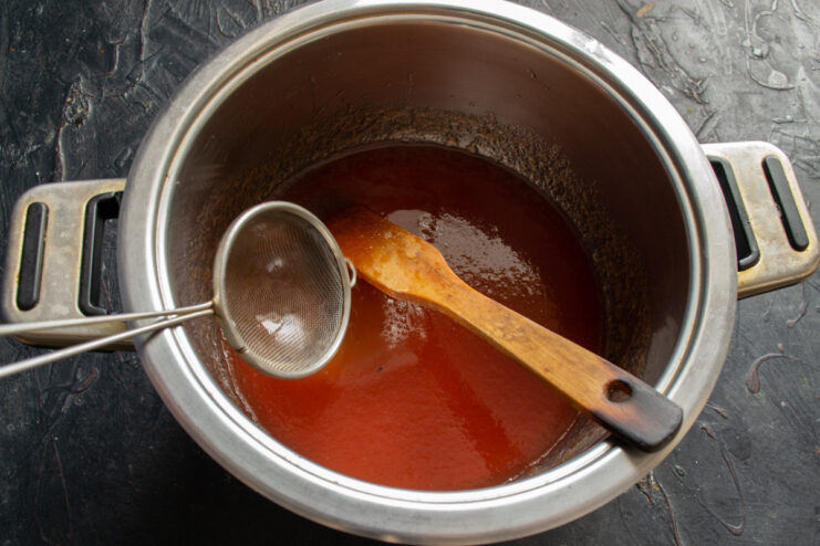 Adding Egg White to the Puree for an Airy Texture An egg white being added to the fruit puree in a mixing bowl.