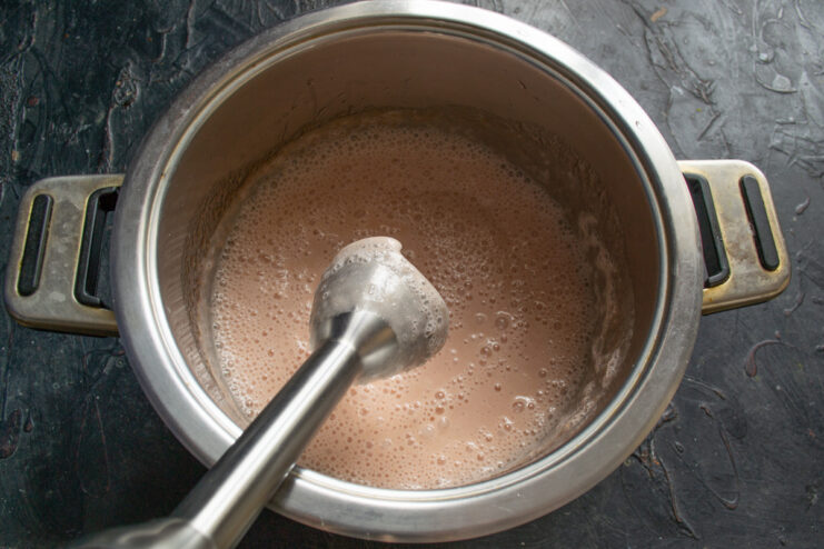 Whipping the Zefir Mixture Until Light and Fluffy Whipping the fruit puree and egg white mixture with an electric mixer until it's light pink and airy.