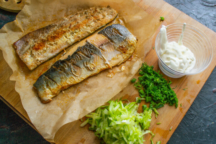 The Result: Perfectly Cooked Salmon and a Spotless Pan Lifting the parchment paper with the cooked salmon out of the skillet, revealing a clean pan underneath.