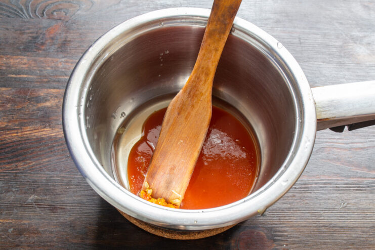 Adding Tomato Purée to the Sauté Pan Tomato puree being added to a deep sauté pan.