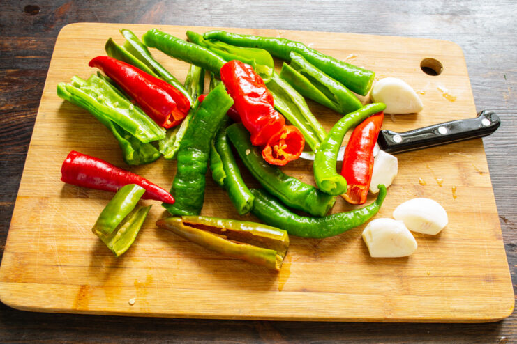 Preparing Chili Peppers for Adjika Halved red chili peppers with seeds and stems removed, ready for processing.