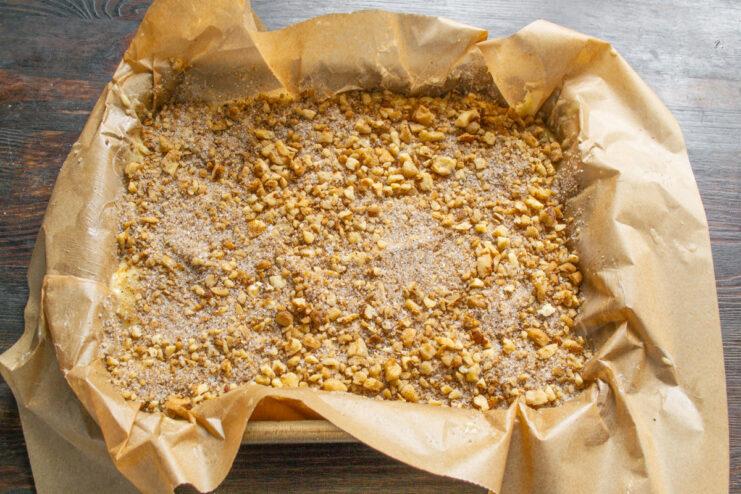 Baking the Orange and Walnut Cake The cake pan with batter and topping placed inside an oven to bake.