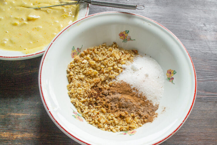 Preparing the Walnut Topping Finely chopped walnuts in a bowl, ready to be used as a topping for the cake.