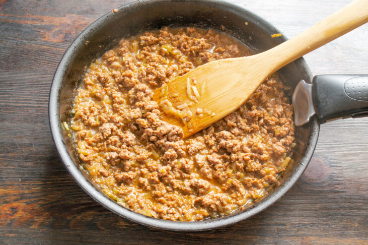 Cooked Ground Beef Filling for Blinchiki Cooked and seasoned ground beef and onion filling in a skillet.