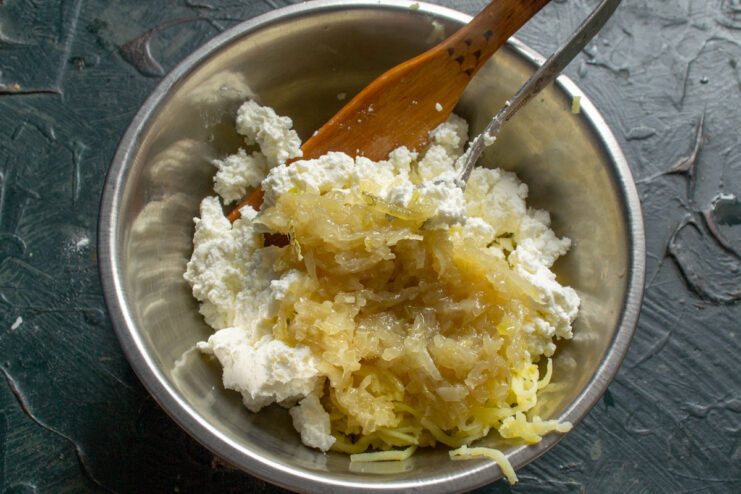Caramelizing Onions to Add Flavor to the Filling Chopped onions being sautéed in a pan until golden and caramelized.