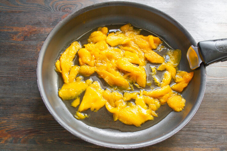 Preparing the Pumpkin for the Filling Finely chopped raw pumpkin pieces seasoned with salt in a bowl.