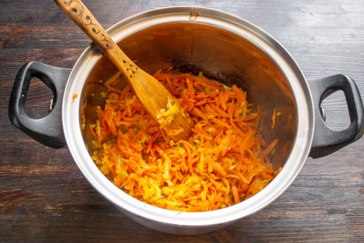 The perfect sautéed vegetable base (zazharka/mirepoix) for soups A close-up of the sautéed vegetable base of onions, carrots, and celery in a pot.