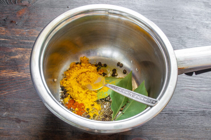 Step 6: Preparing the base for the marinade Salt and sugar being poured into a stainless steel saucepan to create the marinade.
