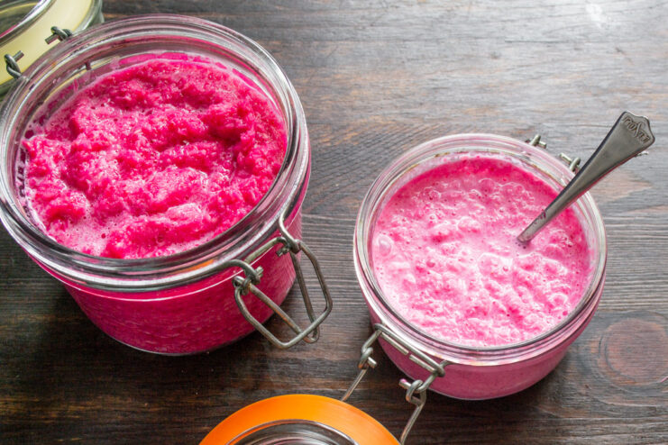 Enjoy Your Homemade Fiery and Creamy Horseradish Sauce! A jar of homemade horseradish sauce with beets, with a small serving bowl next to it.