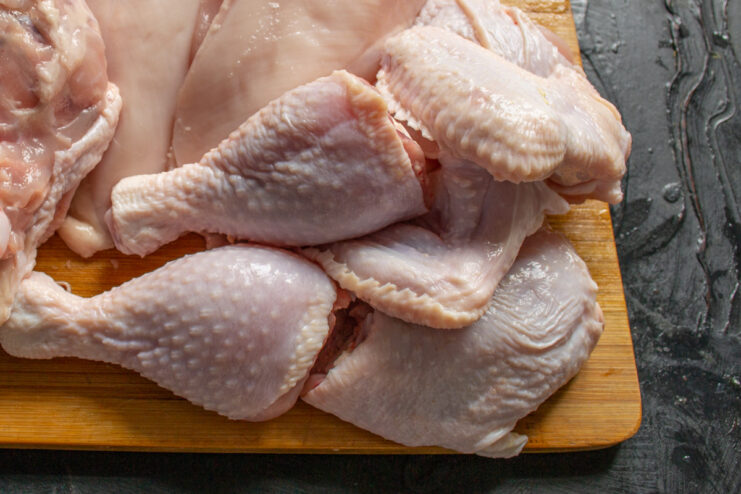 Using Chicken Wings and Drumsticks for a Flavorful Pâté Base Raw chicken parts, including wings and drumsticks, in a pot ready for cooking.