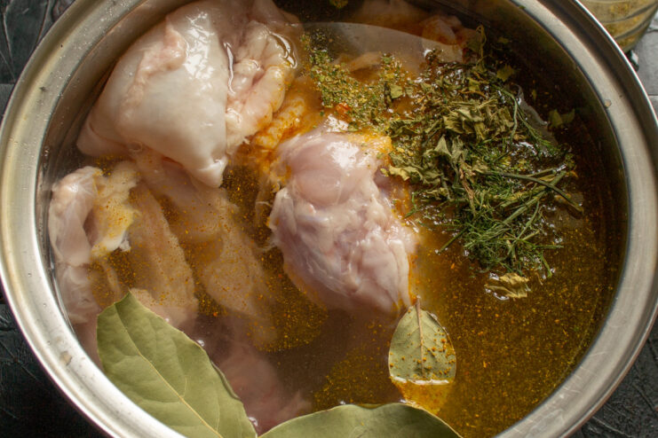 Perfectly Cooked Chicken for a Silky Smooth Pâté Cooked chicken pieces in a pot, so tender the meat is falling off the bone.