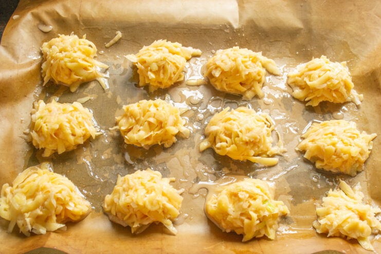 Portioning Draniki Batter onto a Baking Sheet Scooping portions of the potato pancake mixture onto a prepared baking sheet.