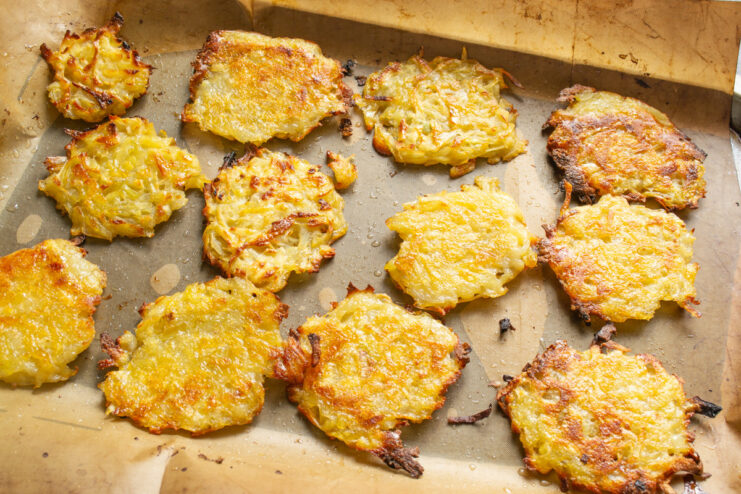 Tip for Evenly Cooked Draniki: Rotate the Baking Sheet A baking sheet with half-baked draniki being rotated for even cooking.