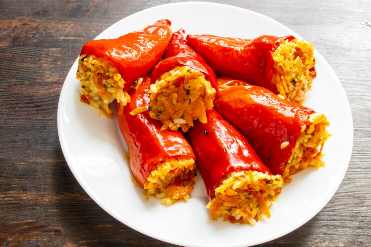 Serving Warm Stuffed Peppers with a Creamy Sauce A serving of warm meatless stuffed peppers in a bowl, ready to be eaten.
