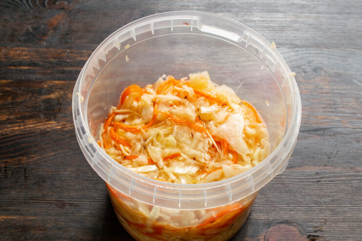 The Fermentation Process: Letting the Cabbage Sit at Room Temperature A sealed jar of cabbage fermenting on a kitchen counter.