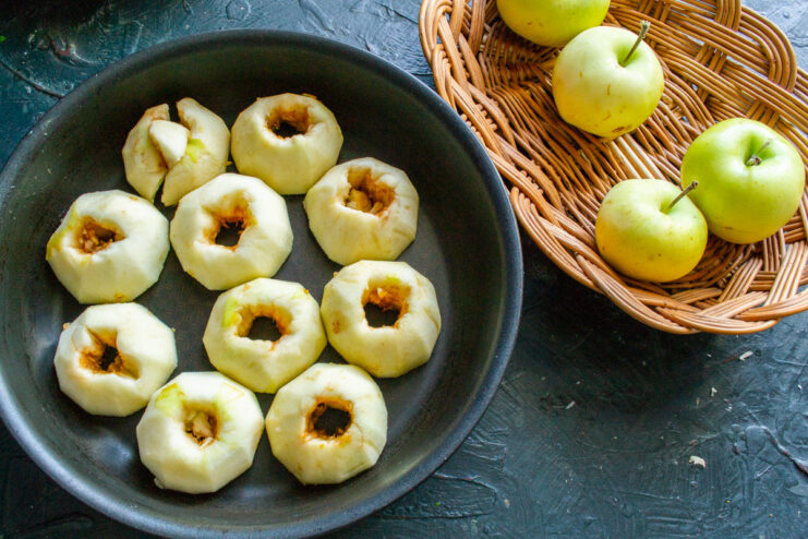 Arranging Apples in the Skillet for Tarte Tatin Apple halves arranged cut-side down in a black skillet to measure the quantity for the pie.