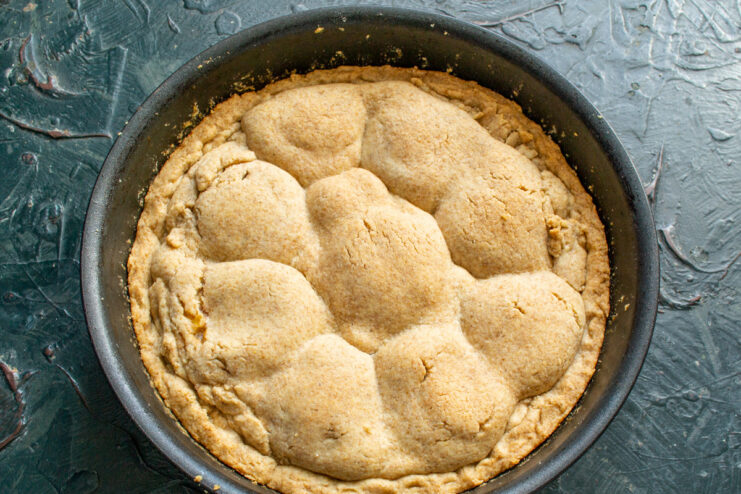 Baking the Tarte Tatin in the Oven The skillet with the Tarte Tatin going into a hot oven to bake.