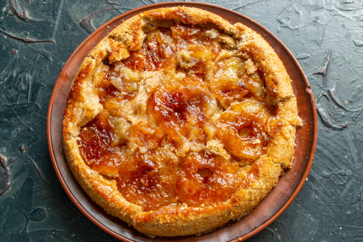 Freshly Baked Tarte Tatin Resting After Baking The golden-brown baked Tarte Tatin in its skillet, fresh out of the oven.