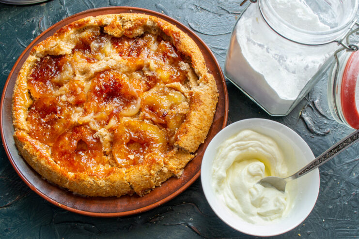 Preparing a Creamy Topping with Smetana and Sugar Whipping high-fat sour cream and powdered sugar in a bowl to make a cream topping.