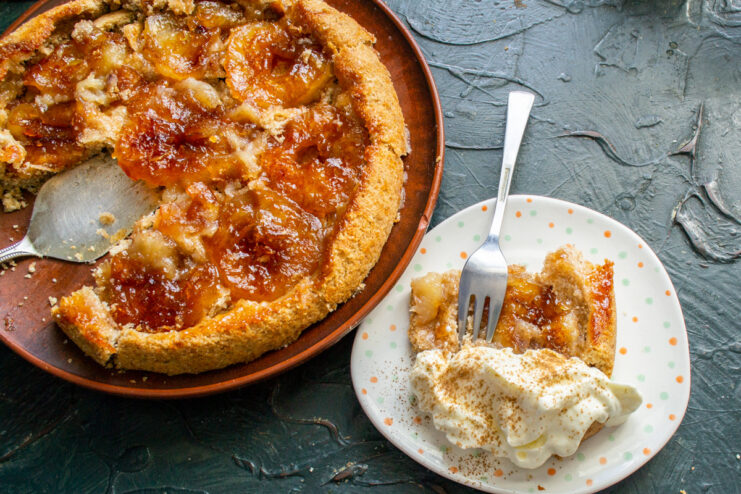 Serving Tarte Tatin with a Dollop of Smetana Cream A slice of Tarte Tatin on a plate, served with a generous spoonful of smetana cream.