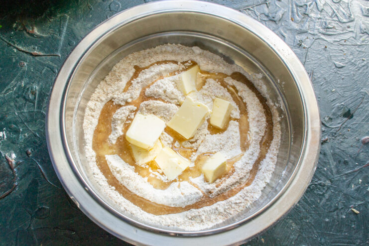 Adding Fats to the Flour for a Flaky Crust Cubed butter and vegetable oil added to the flour mixture for the pie dough.