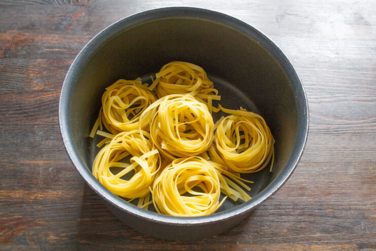 Cooking Pasta Nests to Al Dente Perfection Pasta nests being cooked in a pot of boiling water.