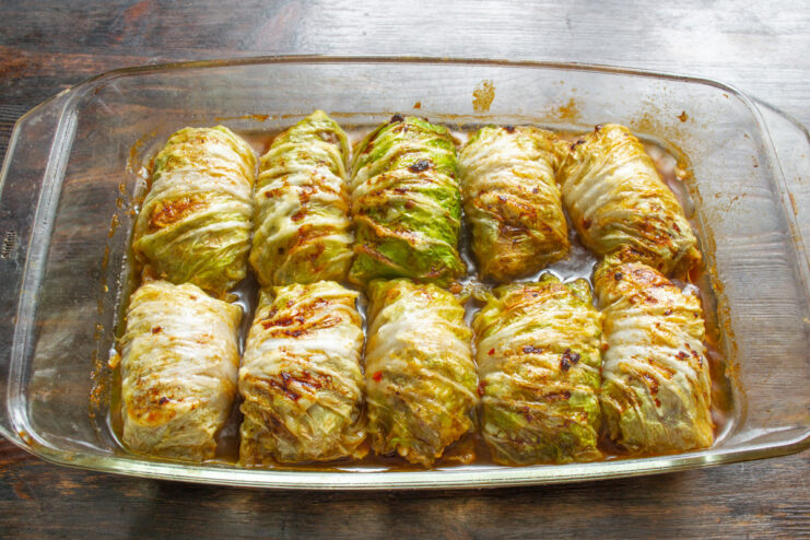 Adding Soy Sauce and Broth Before Baking Pouring soy sauce over the cabbage rolls in a baking dish before baking.