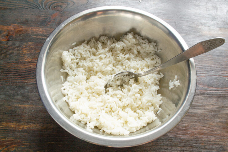 Cooking Rice for the Cabbage Roll Filling A small pot filled with perfectly cooked white rice for the filling.
