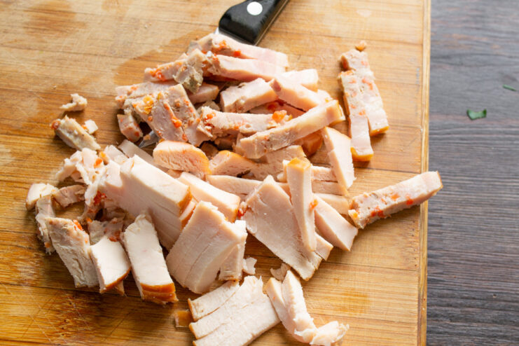 Preparing the Ham for the Sandwich Filling Close-up of diced ham on a cutting board for the sandwich filling.