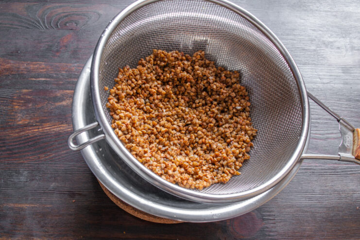 Sorting and Rinsing Buckwheat Groats A close-up of raw buckwheat groats in a bowl being prepared for cooking.