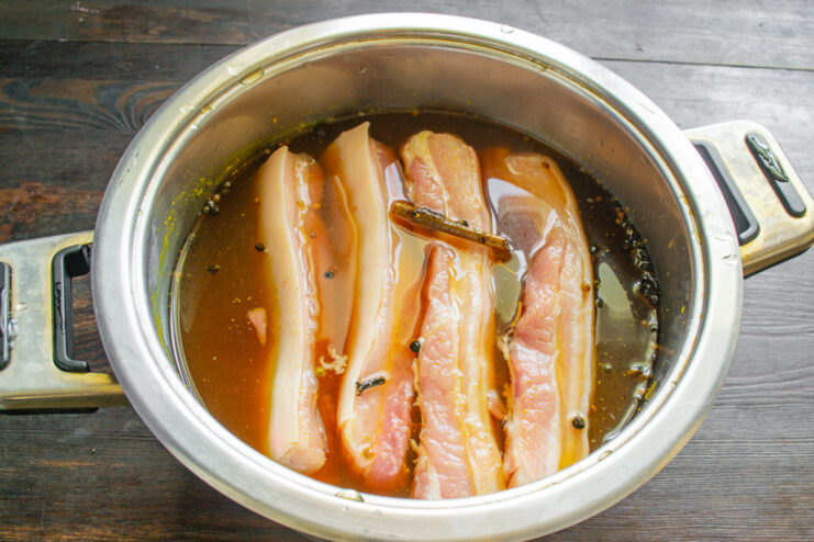 Letting the Pork Belly Cure at Room Temperature A pot with pork belly in brine, covered, ready for the first stage of curing.