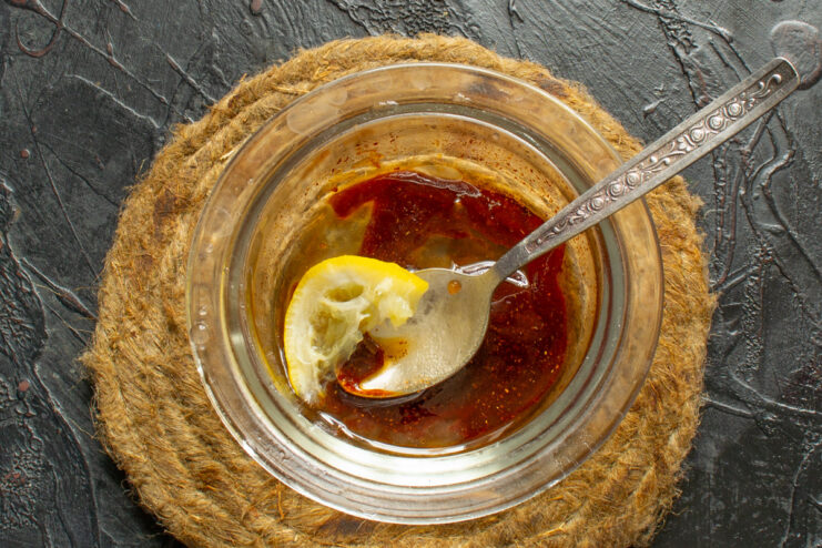 Mixing ingredients for the sweet and savory honey glaze. A small bowl with ingredients for the honey glaze: honey, soy sauce, and mustard.