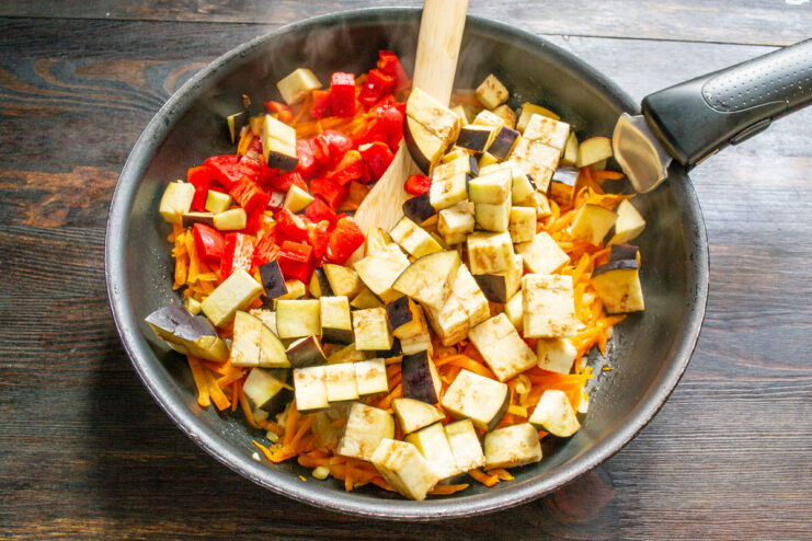 Preparing the Star Ingredient - Dicing fresh, firm eggplants for the caviar. Fresh eggplants being diced into small cubes on a cutting board.