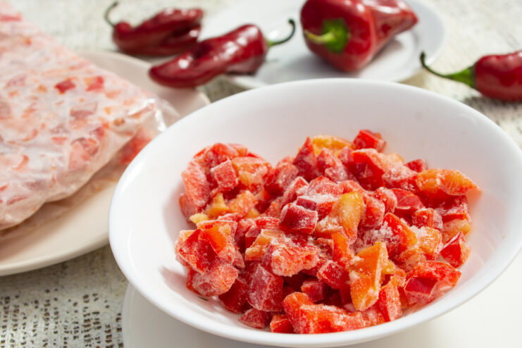 Diced red bell peppers in a bowl, prepared for freezing for the winter.