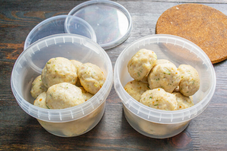 Storing cooked and cooled chicken meatballs for future meals. Cooked and cooled chicken tefteli being placed into airtight containers for freezing.