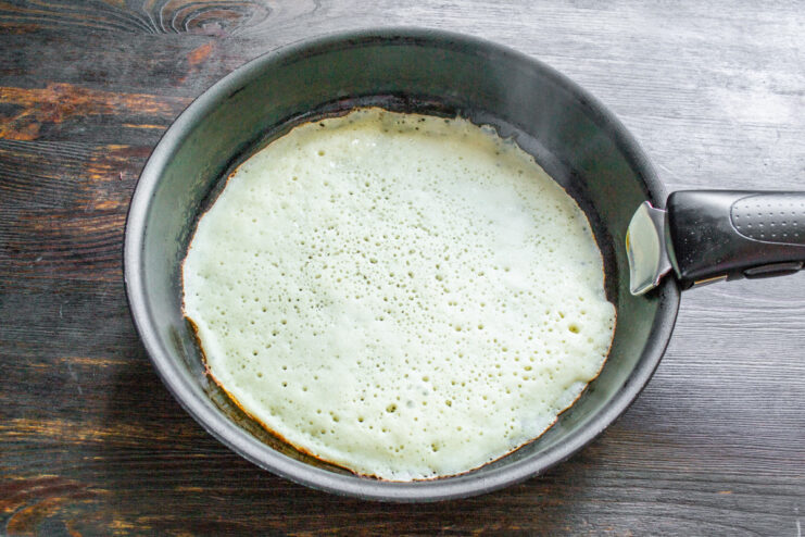 Pouring the batter directly from the bottle onto the hot pan. Pouring pancake batter from a plastic bottle onto a hot, greased skillet.