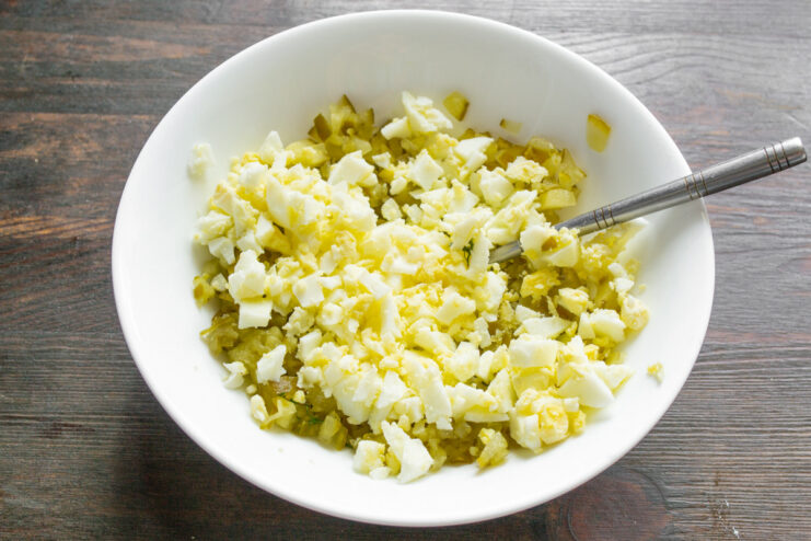 Combining Egg and Pickle for the Sauce Base A bowl containing diced salted pickle and chopped hard-boiled egg.