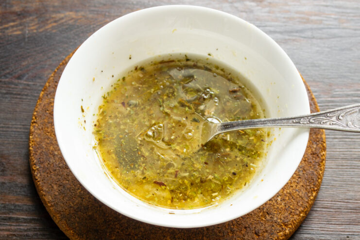 How to Make a Classic Vinaigrette Dressing for Salads Ingredients for vinaigrette dressing being mixed in a small bowl.