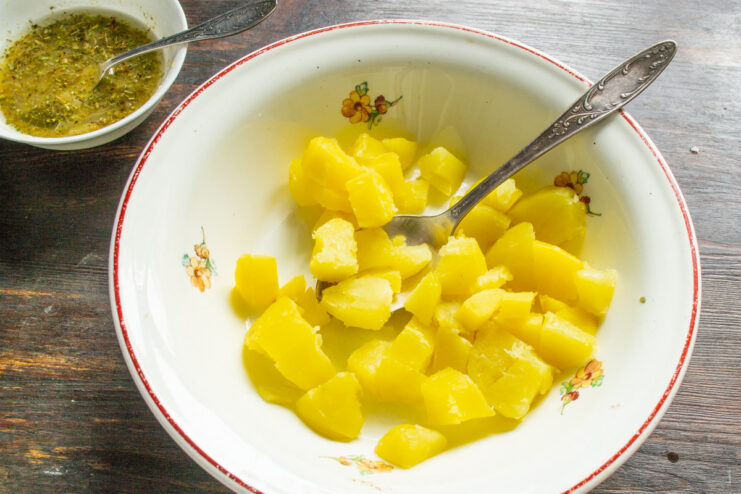 Preparing the Potatoes for the Salad Diced boiled potatoes in a white bowl, ready for the salad.