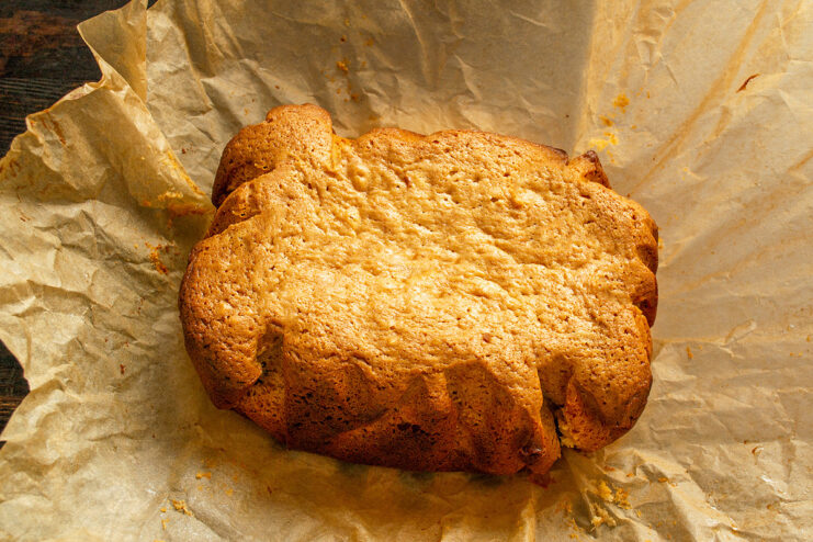 Step 10: Cooling the finished cake on a wire rack. A golden-brown condensed milk cake cooling on a wire rack.
