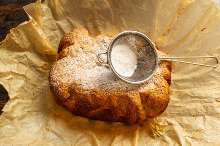 Step 11: Decorating the cake with powdered sugar. Dusting the cooled cake with powdered sugar using a sieve.