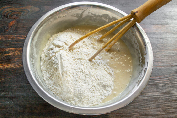 Step 5: Mixing the batter and letting it rest. A smooth cake batter in a white bowl with a whisk.