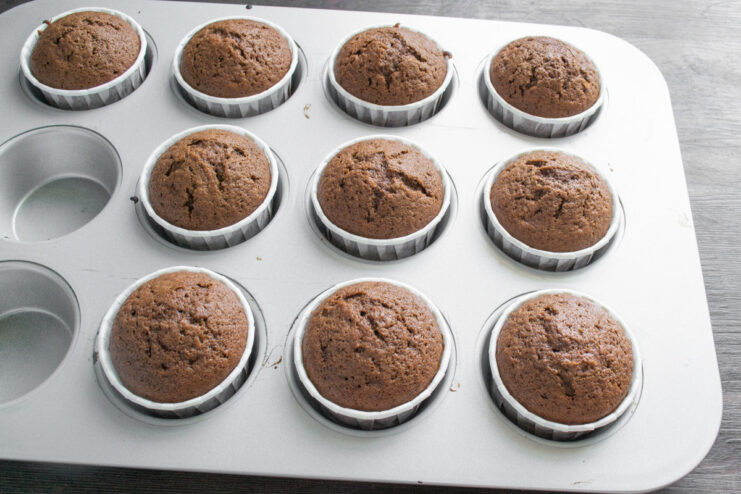 Step 7: Baked Coca-Cola cupcakes fresh from the oven Freshly baked chocolate cupcakes in a muffin tin.