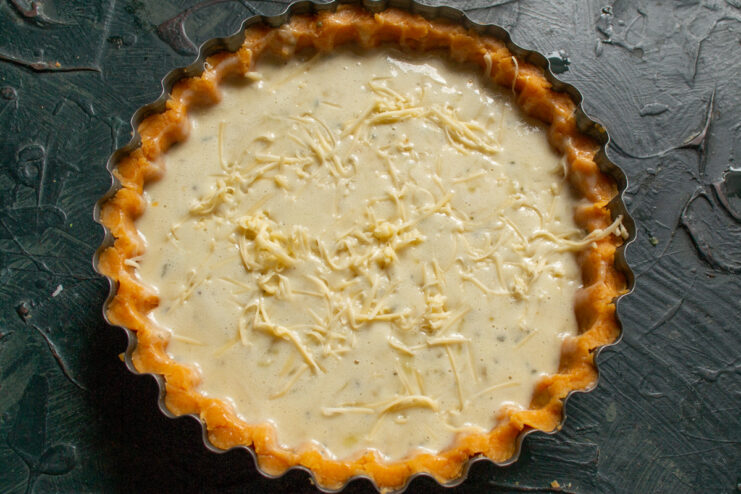 Topping the Quiche with Grated Cheese Sprinkling grated Parmesan or cheddar cheese over the top of the quiche before baking.