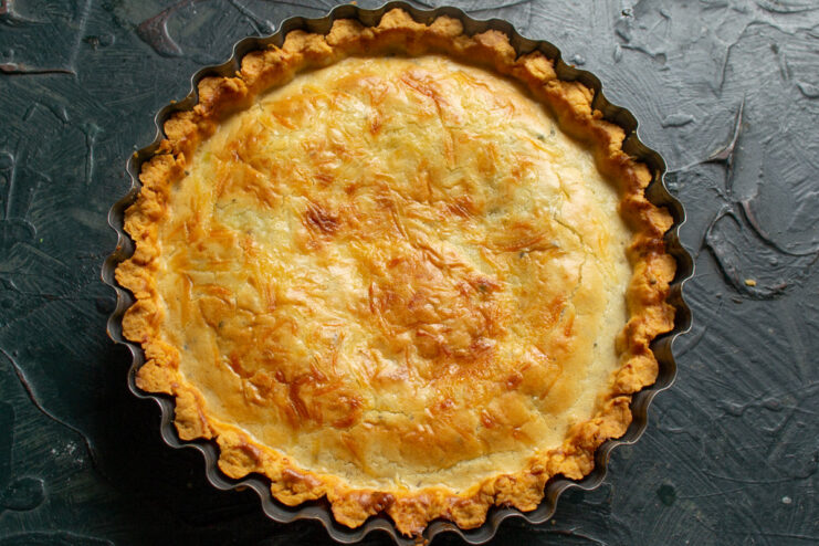 Baking the Quiche Until Golden Brown The onion and cheddar quiche baking in the oven, with the top turning golden brown.