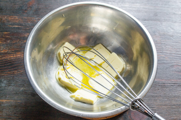 Quick tip for softening butter for baking A glass bowl with butter being placed in an oven to soften.