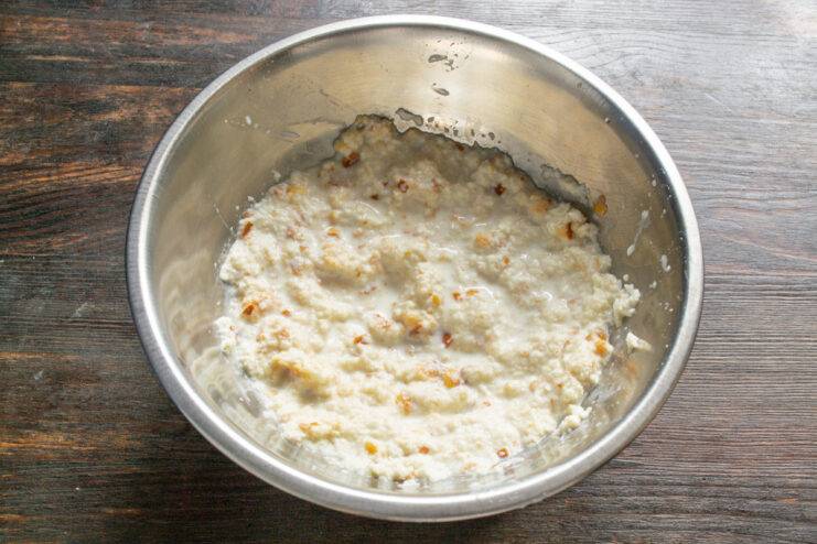 Mashing Soaked Bread into a Paste Mashing soaked bread into a smooth paste in a bowl.