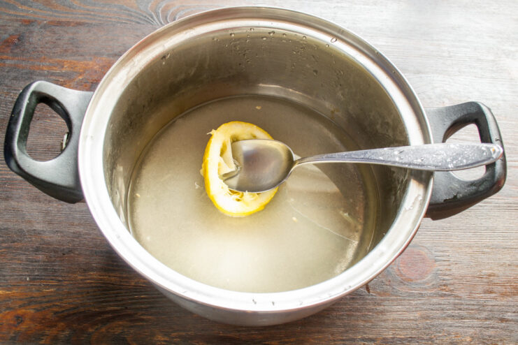 Making the Sugar Syrup for Candying Granulated sugar being added to a pot of water to make syrup.